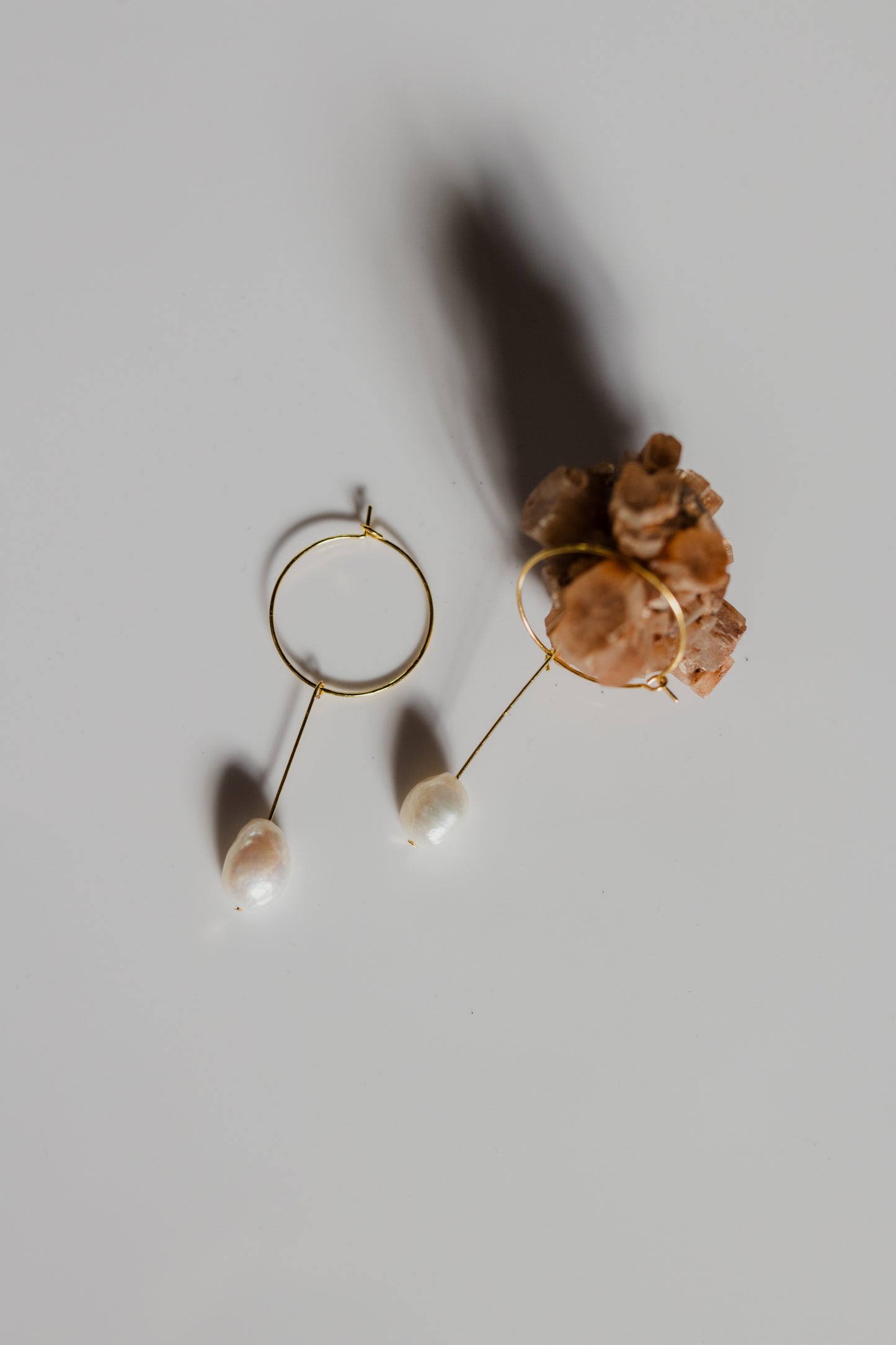 Slightly different white pearl earrings gold