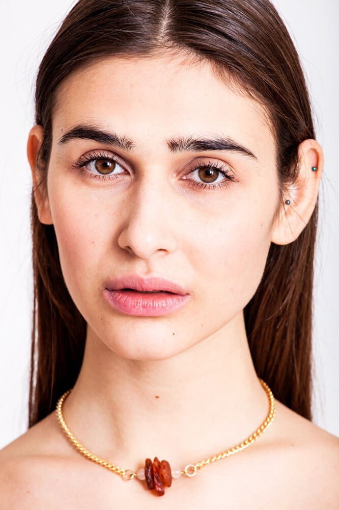 The amber nuggets are in the centre of the necklace with rosequartz beads on the side featuring galvanized metal components.