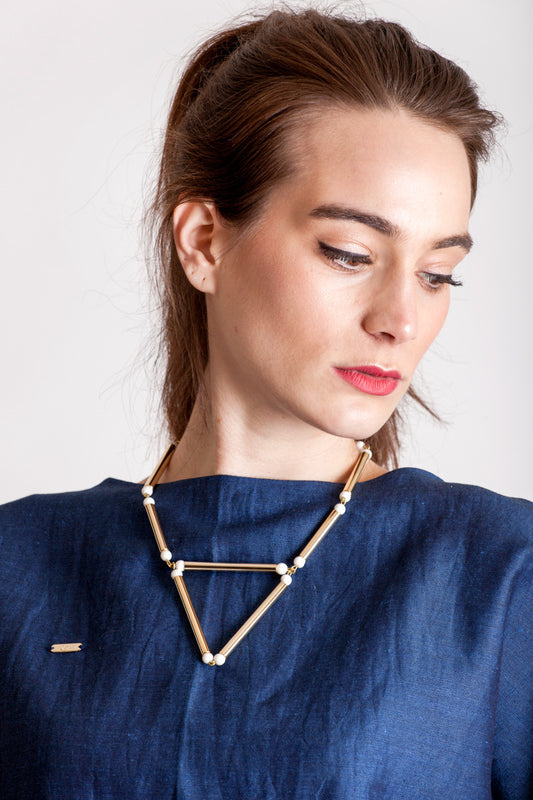 Aztec necklace is made of hand-cut and galvanized brass, white coral and galvanized metal components.