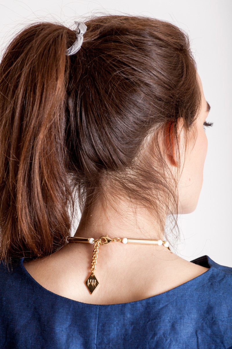 Aztec necklace is made of hand-cut and galvanized brass, white coral and galvanized metal components.