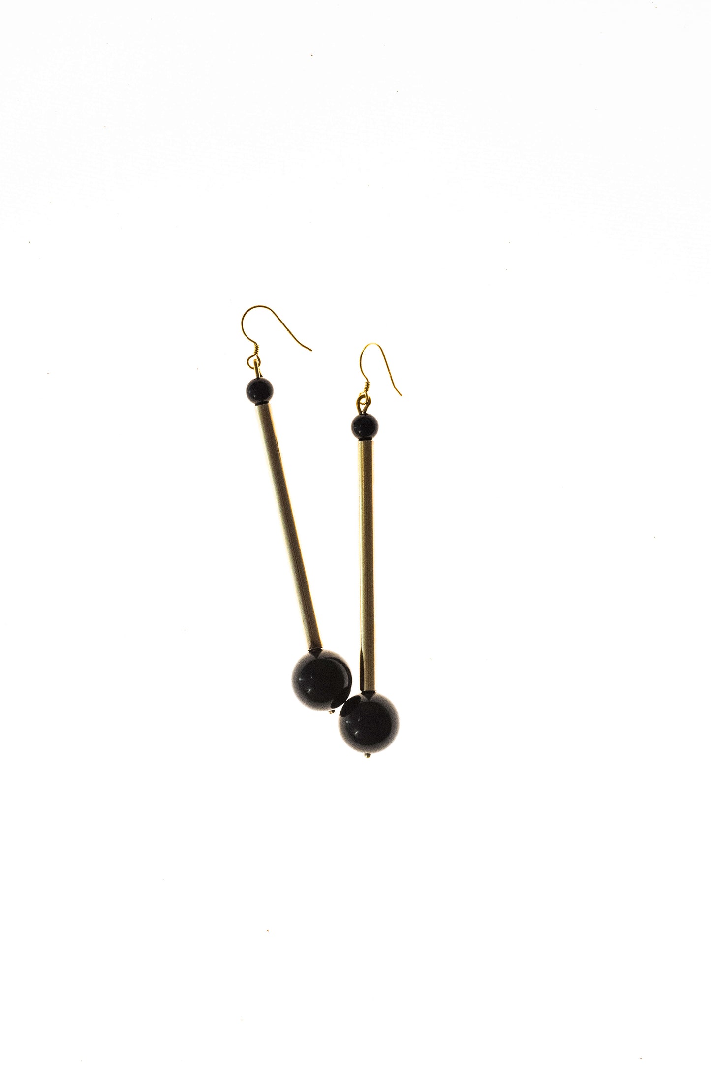 Earrings made of hand-cut, hand-polished and 24K gold-plated brass, onyx and gold plated sterling silver.