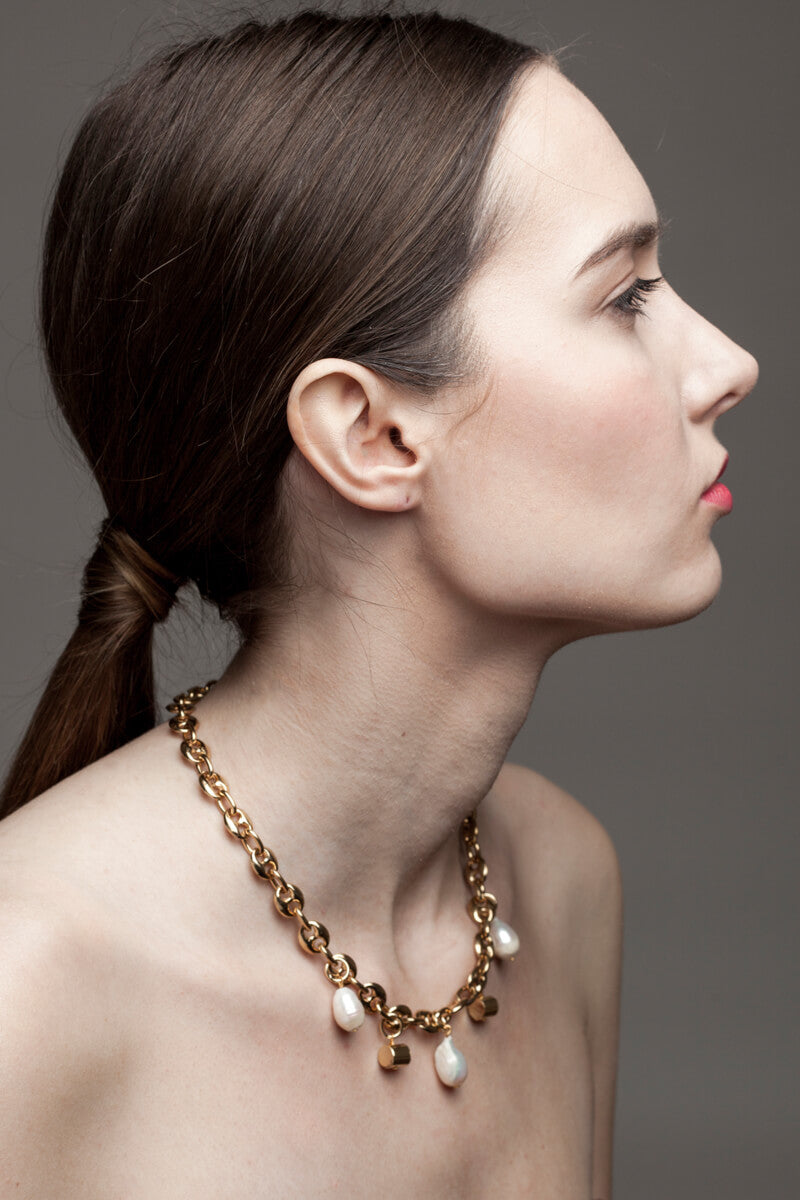 This necklace features 24K gold-plated chain called coffee beans chain and hand cut and 24K gold-plated brass and freshwater pearls.