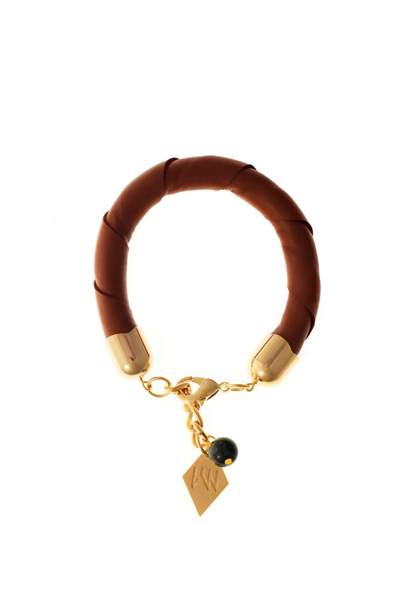 The no. 13 edition of the handcuff bracelet is made of cognac brown leather with galvanized metal components and aventurine.