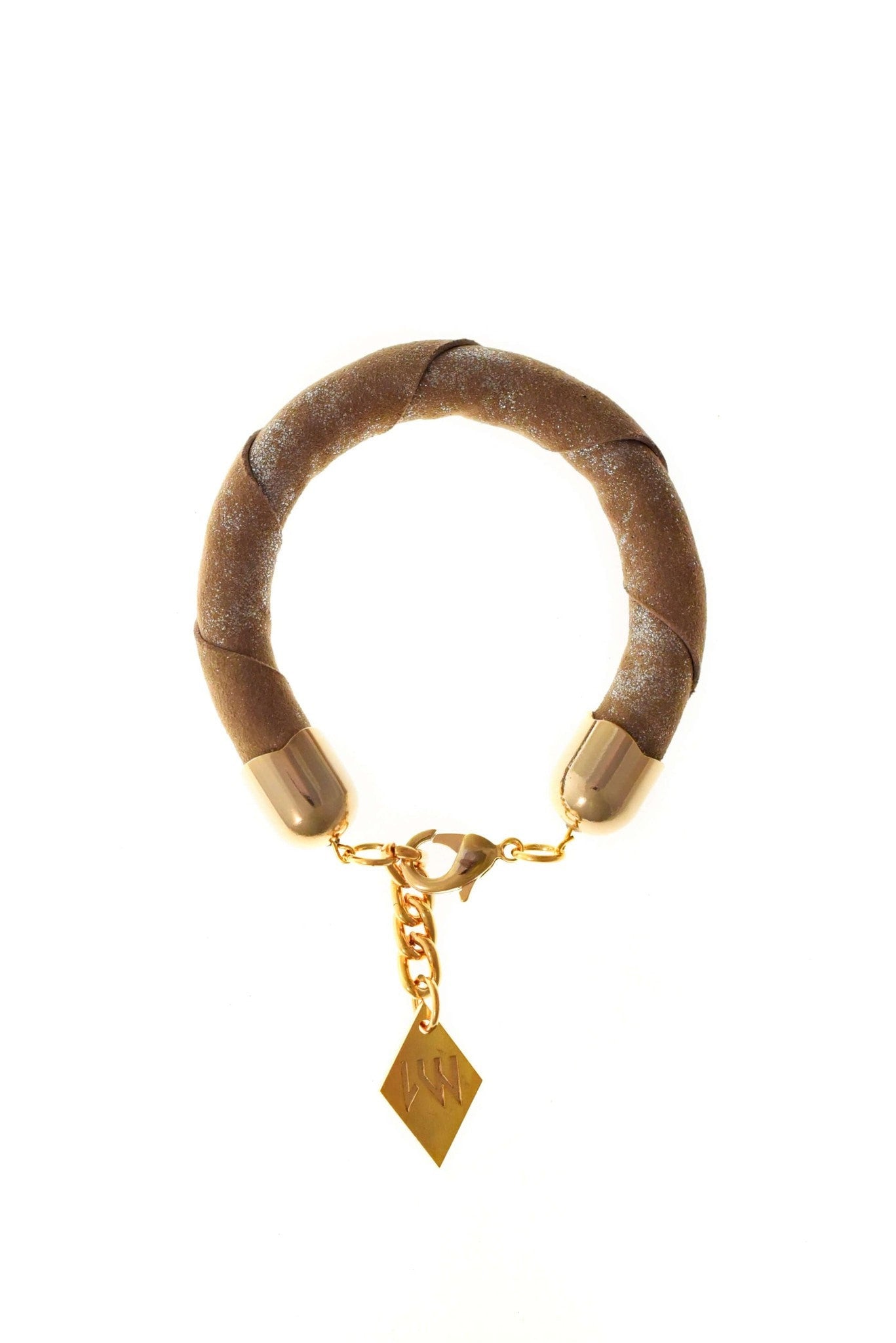 The no. 15 edition of the handcuff bracelet is made of beige suede with silver details and galvanized metal components. gold edition.