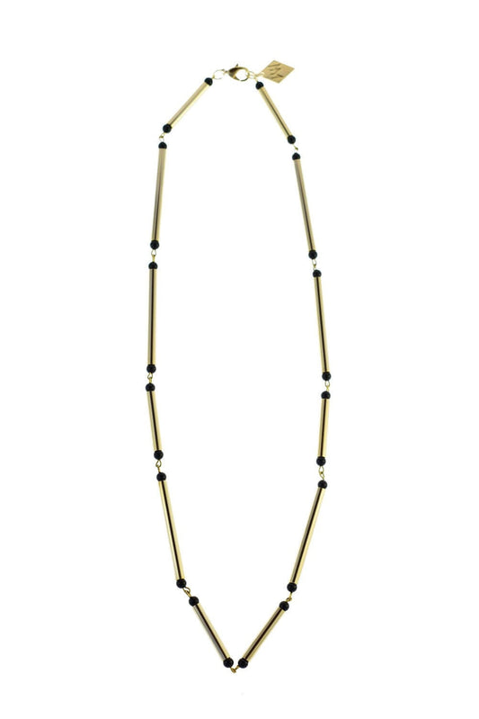 Hidden lines gold edition made of hand-cut, hand polished and galvanized brass featuring black onyx.