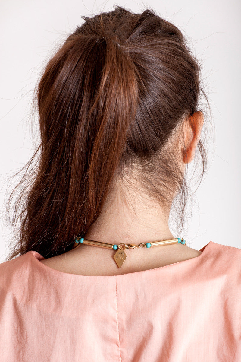Hidden lines long necklace made of hand-cut, hand polished and galvanized brass featuring turquoise.