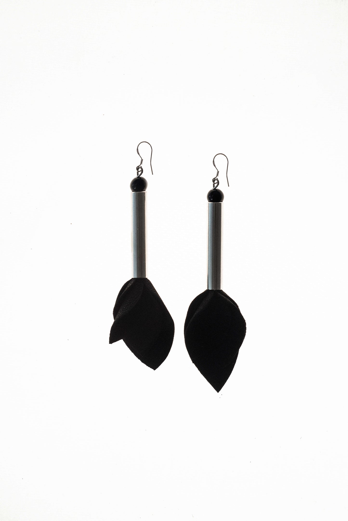 Earrings made of hand-cut leather, galvanized brass, onyx and sterling silver.