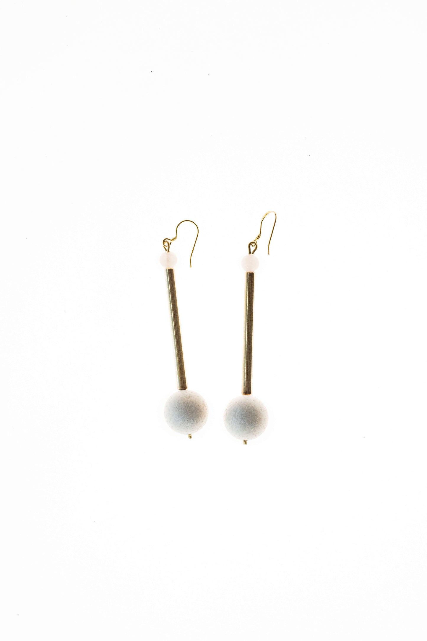 Earrings made of hand-cut, hand-polished and 24K gold-plated brass, white coral, rose quartz and gold plated sterling silver.