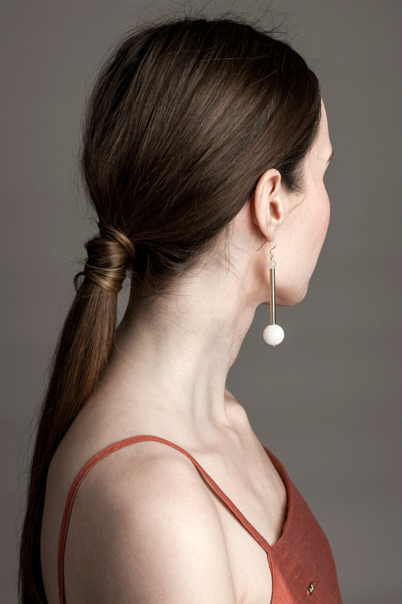 Earrings made of hand-cut, hand-polished and 24K gold-plated brass, white coral, rose quartz and gold plated sterling silver.