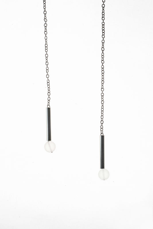 The piece features hand-cut and galvanized brass, quartz and galvanized chain.