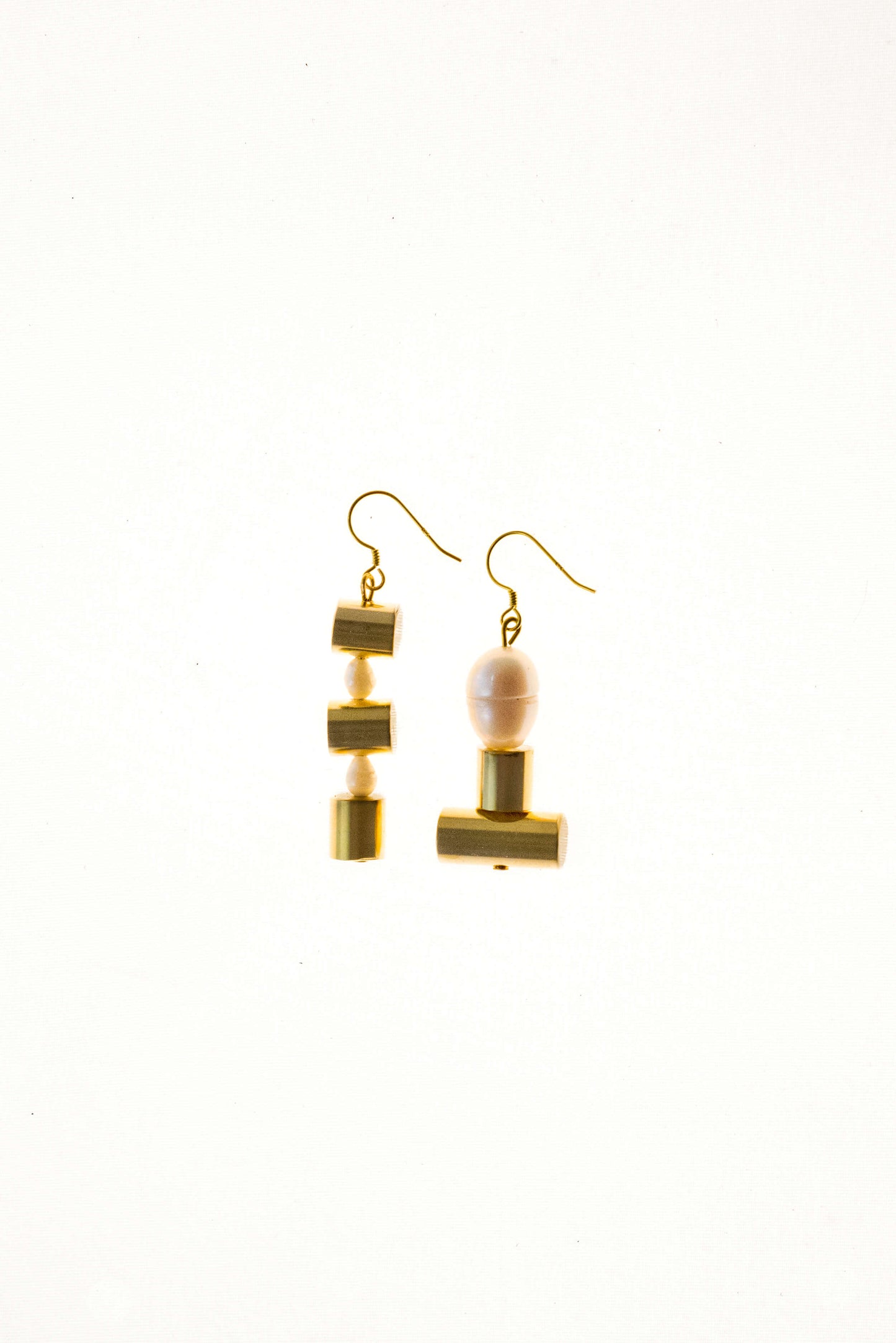 This mismatched earrings are made of hand cut and 24K gold-plated brass, freshwater pearls and gold-plated sterling silver.