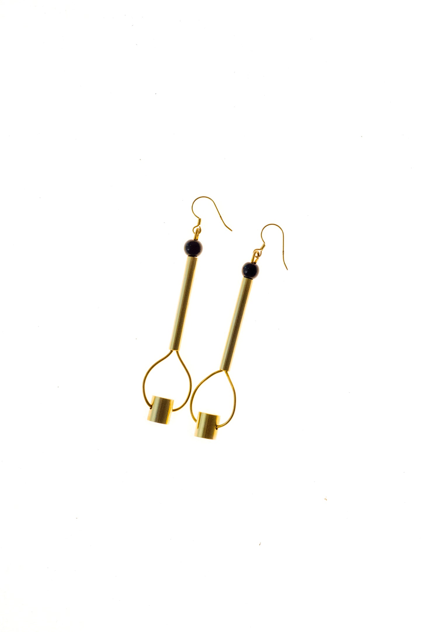 This beautiful statement earrings feature hand cut and 24K gold-plated brass and onyx.