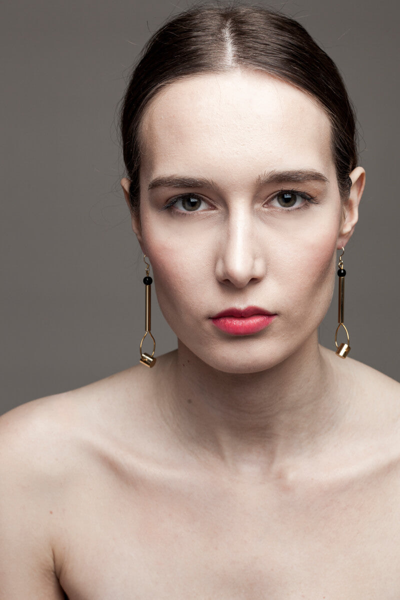 This beautiful statement earrings feature hand cut and 24K gold-plated brass and onyx.