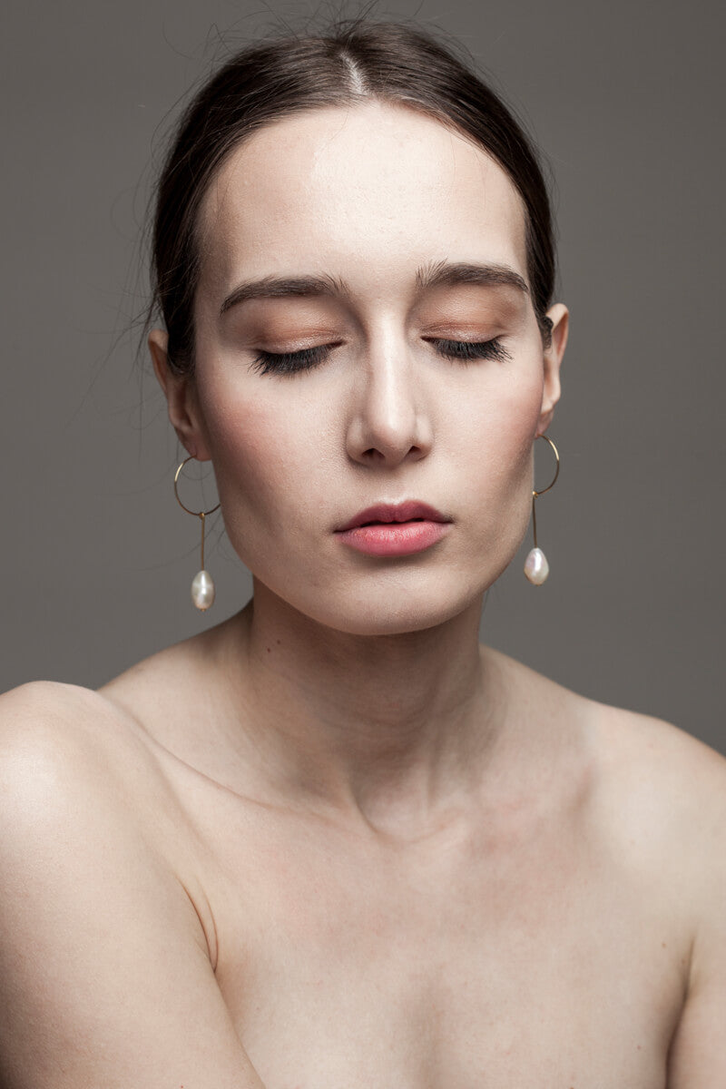 Earrings made of 24K gold plated brass and freshwater pearl.