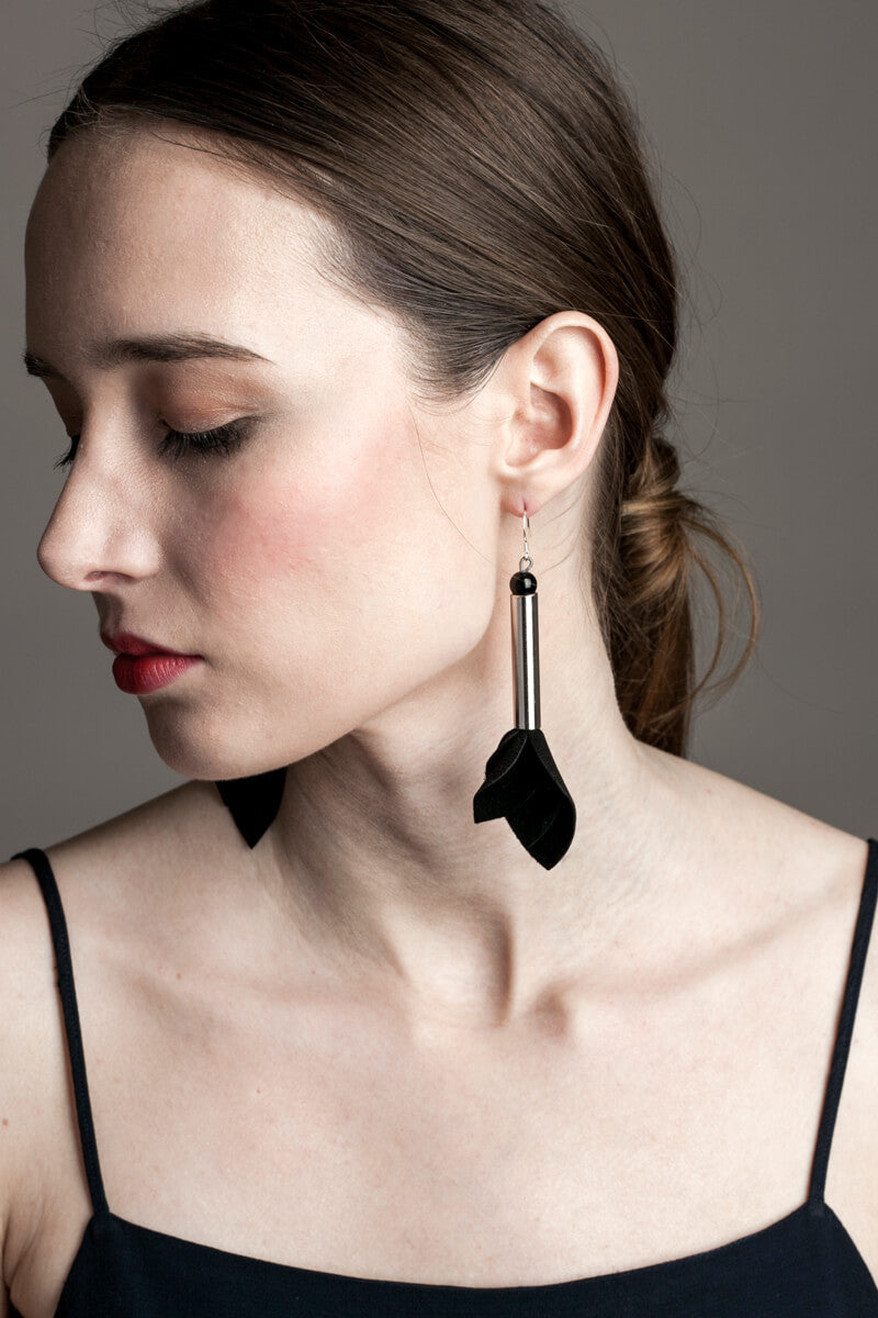 Earrings made of hand-cut leather, galvanized brass, onyx and sterling silver.