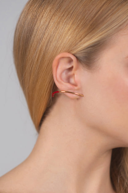 Bow earring with a hint of red