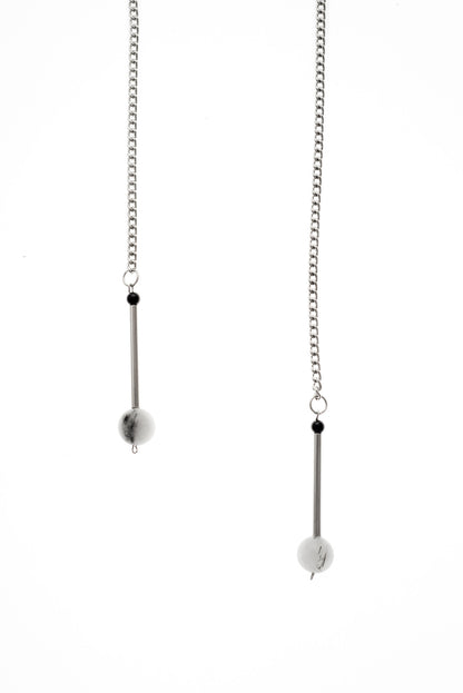 The Bellevue necklace features hand-cut and galvanized brass, onyx, rutilated quartz and galvanized chain.