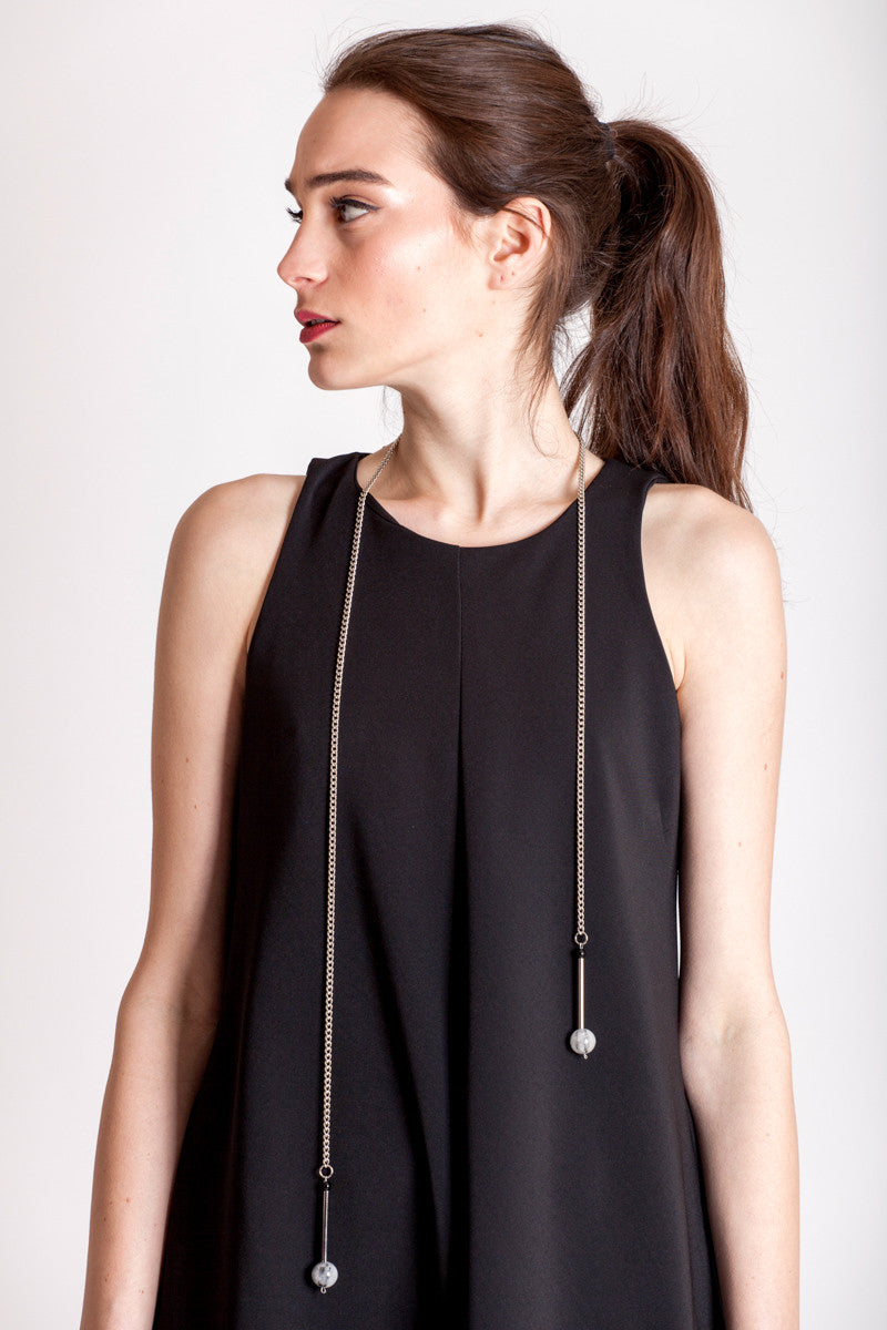 The Bellevue necklace features hand-cut and galvanized brass, onyx, rutilated quartz and galvanized chain.