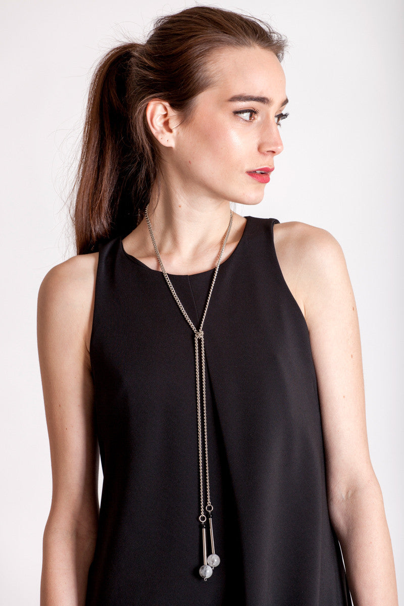 The Bellevue necklace features hand-cut and galvanized brass, onyx, rutilated quartz and galvanized chain.