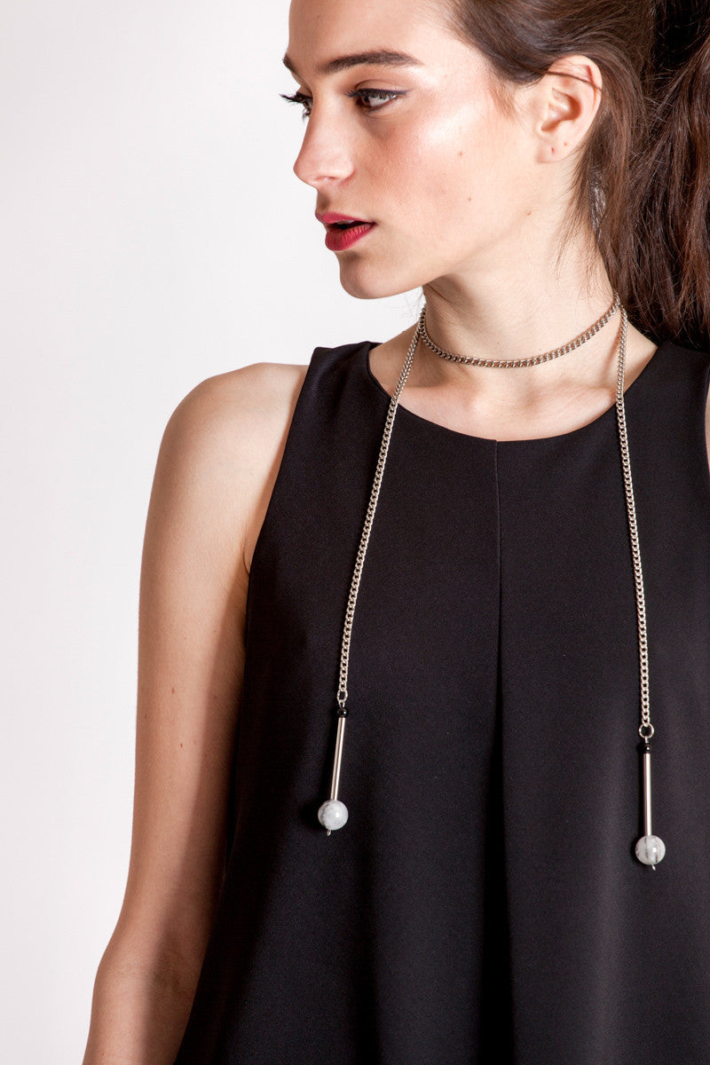 The Bellevue necklace features hand-cut and galvanized brass, onyx, rutilated quartz and galvanized chain.