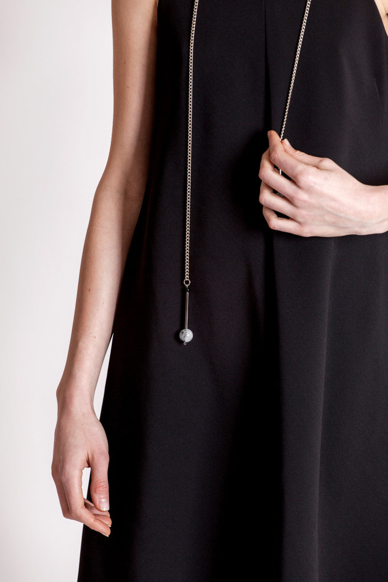 The Bellevue necklace features hand-cut and galvanized brass, onyx, rutilated quartz and galvanized chain.