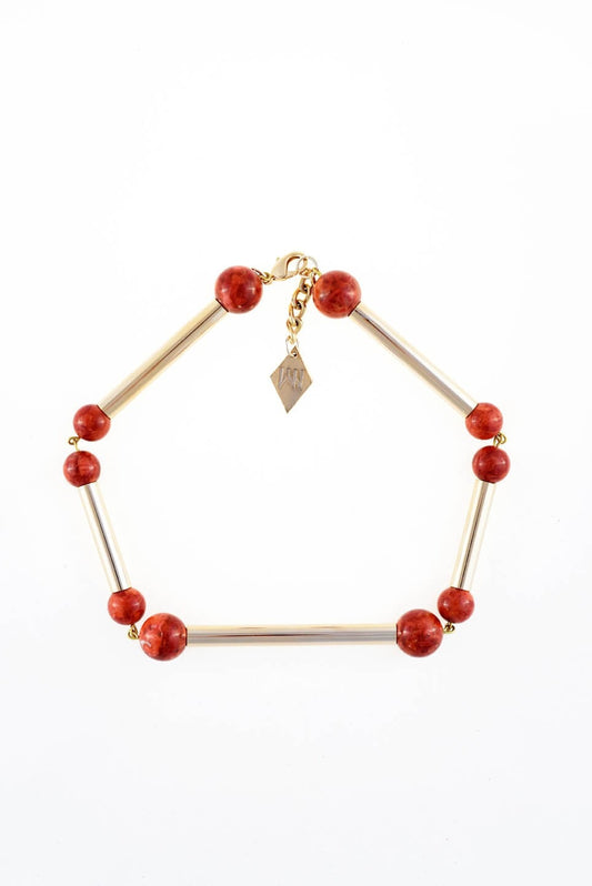 The Bonbon necklace made of warm red coral (gold edition) and cold brass, which was hand-cut and galvanized.