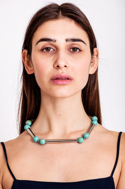 The Bonbon necklace made of warm turquoise (silver edition) and cold brass, which was hand-cut and galvanized.