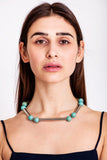 The Bonbon necklace made of warm turquoise (silver edition) and cold brass, which was hand-cut and galvanized.