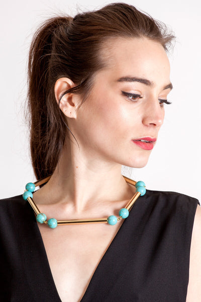 The Bonbon necklace made of warm turquoise (gold edition) and cold brass, which was hand-cut and galvanized.