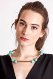 The Bonbon necklace made of warm turquoise (gold edition) and cold brass, which was hand-cut and galvanized.