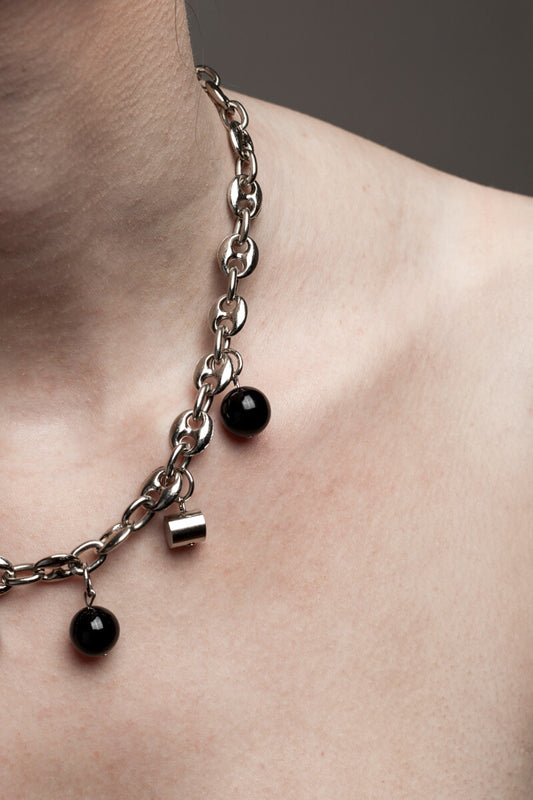 This necklace features galvanized chain called coffee beans chain and hand cut and galvanized brass and onyx.