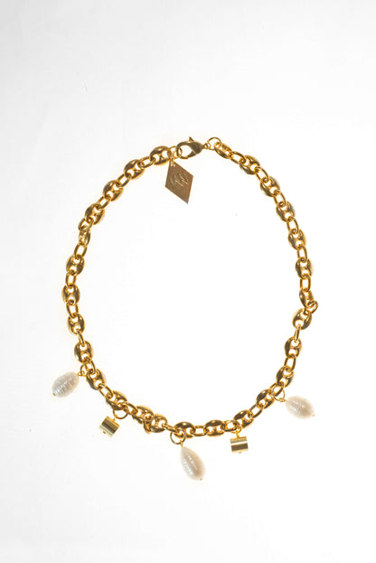This necklace features 24K gold-plated chain called coffee beans chain and hand cut and 24K gold-plated brass and freshwater pearls.