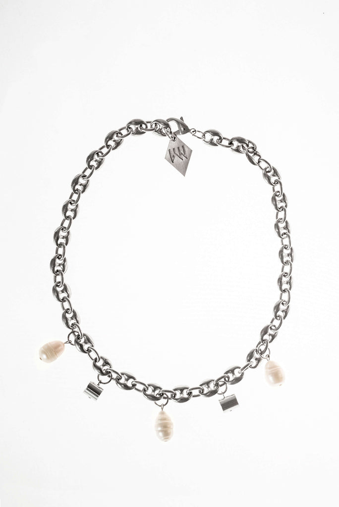 This necklace features galvanized chain called coffee beans chain and hand cut and galvanized brass and freshwater pearls.