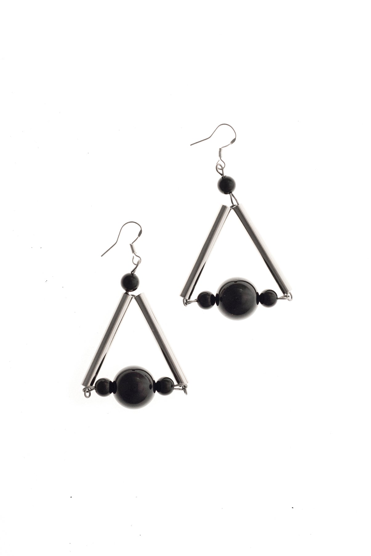 The triangle earrings are made of hand-cut, hand polished and galvanized brass, onyx and sterling silver. 