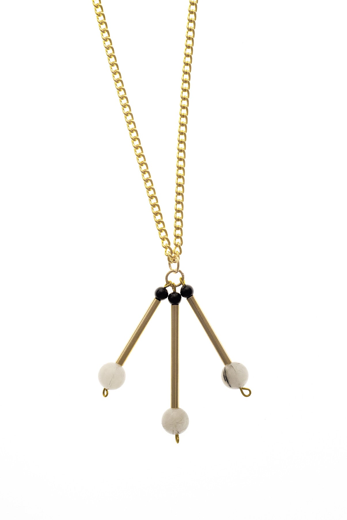 The Elsa necklace is composed of beautiful rutilated quartz, onyx beads and hand-cut and galvanized brass.