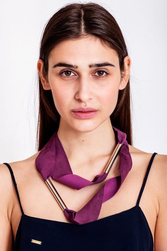 Embrassme necklace made of finest sheep napa, hand-cut, hand polished and galvanized brass and metal components. Purple-gold edition.