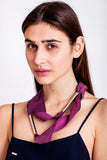 Embrassme necklace made of finest sheep napa, hand-cut, hand polished and galvanized brass and metal components. Purple-gold edition.