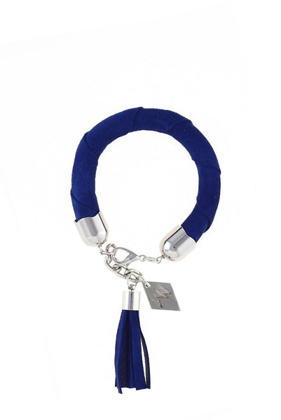 The no. 7 edition of the handcuff bracelet is made of indigo blue suede with galvanized metal components and leather tassel. Silver edition.