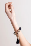 The no. 11 edition of the handcuff bracelet is made of navy blue suede with galvanized metal components with leather tassel. Silver edition.