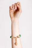 The no. 18 edition of the handcuff bracelet is made of green suede with galvanized metal components. Gold edition.