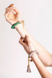 The no. 18 edition of the handcuff bracelet is made of green suede with galvanized metal components. Gold edition.