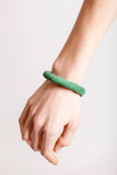 The no. 18 edition of the handcuff bracelet is made of green suede with galvanized metal components. Gold edition.