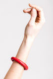 The no. 19 edition of the handcuff bracelet is made of red leather with galvanized metal components with aventurine.