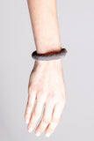 The no. 3 edition of the handcuff bracelet is made of anthracite gray suede with galvanized metal components and quartz. Gold edition.