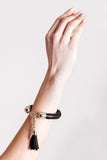 The no. 4 edition of the handcuff bracelet is made of black leather with galvanized metal components and leather tassel. Silver edition. Silver edition.