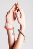 The no. 5 edition of the handcuff bracelet is made of beige suede with galvanized metal components without leather tassel. Gold edition.