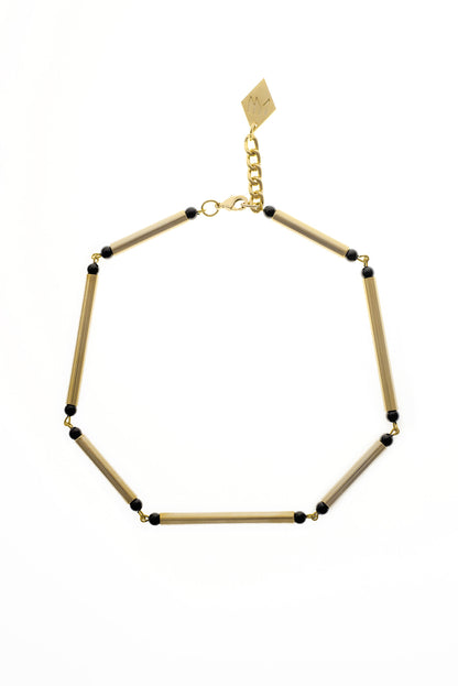 Hidden Lines necklace is made of hand-cut and galvanized brass and onyx.