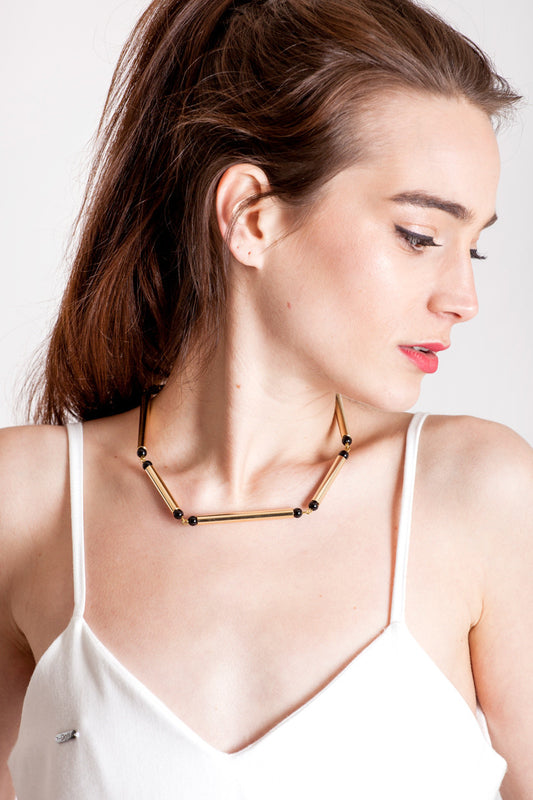 Hidden Lines necklace is made of hand-cut and galvanized brass and onyx.