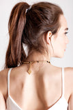 Hidden Lines necklace is made of hand-cut and galvanized brass and onyx.