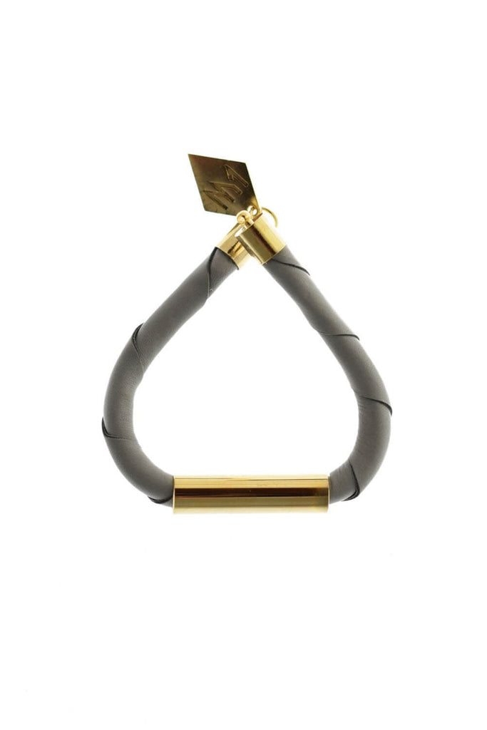 Line cuff made of light gray leather and hand-cut, hand polished and galvanized brass. Gold edition.